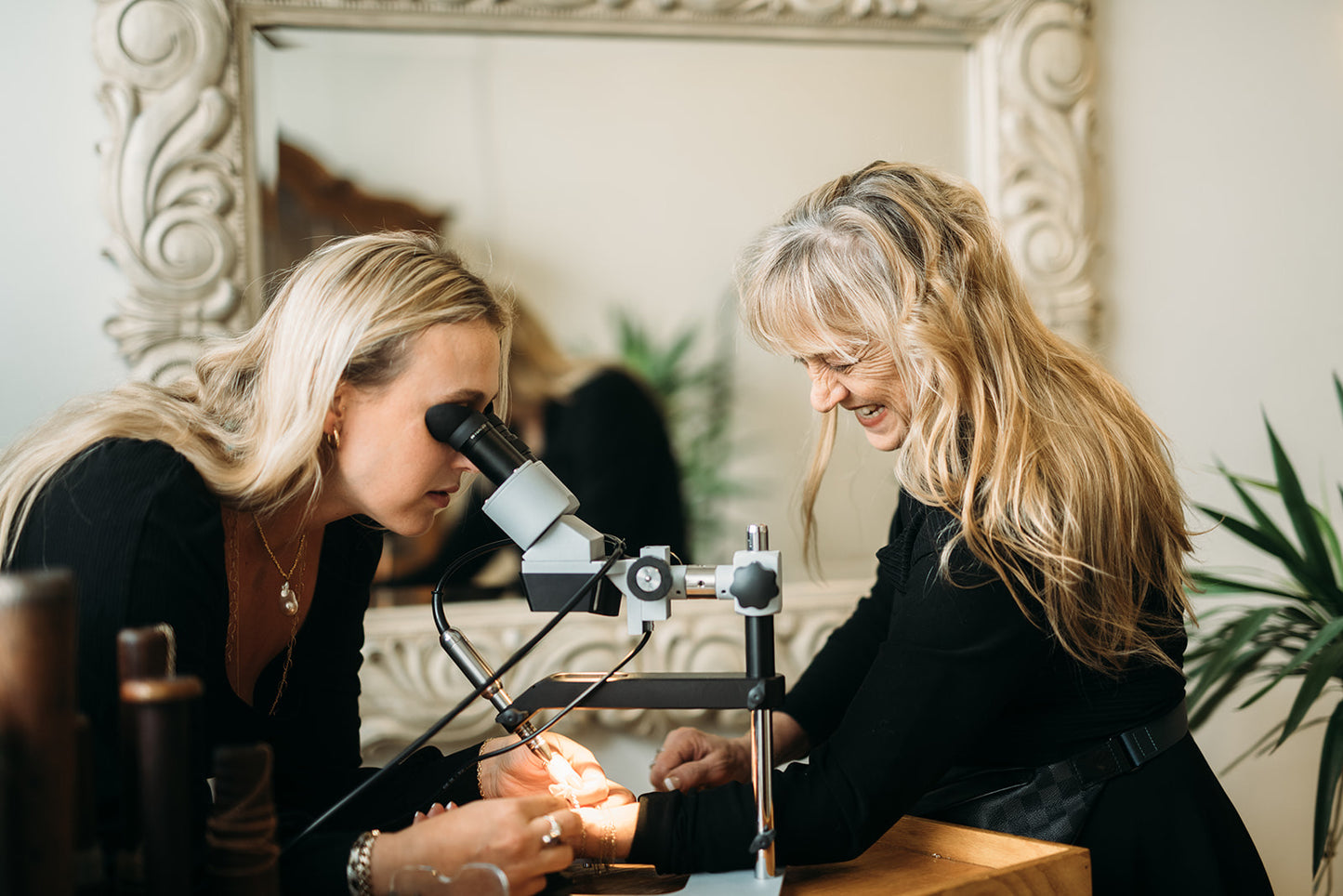 Sacha and Carol in their jewelry studio creating custom permanent jewelry