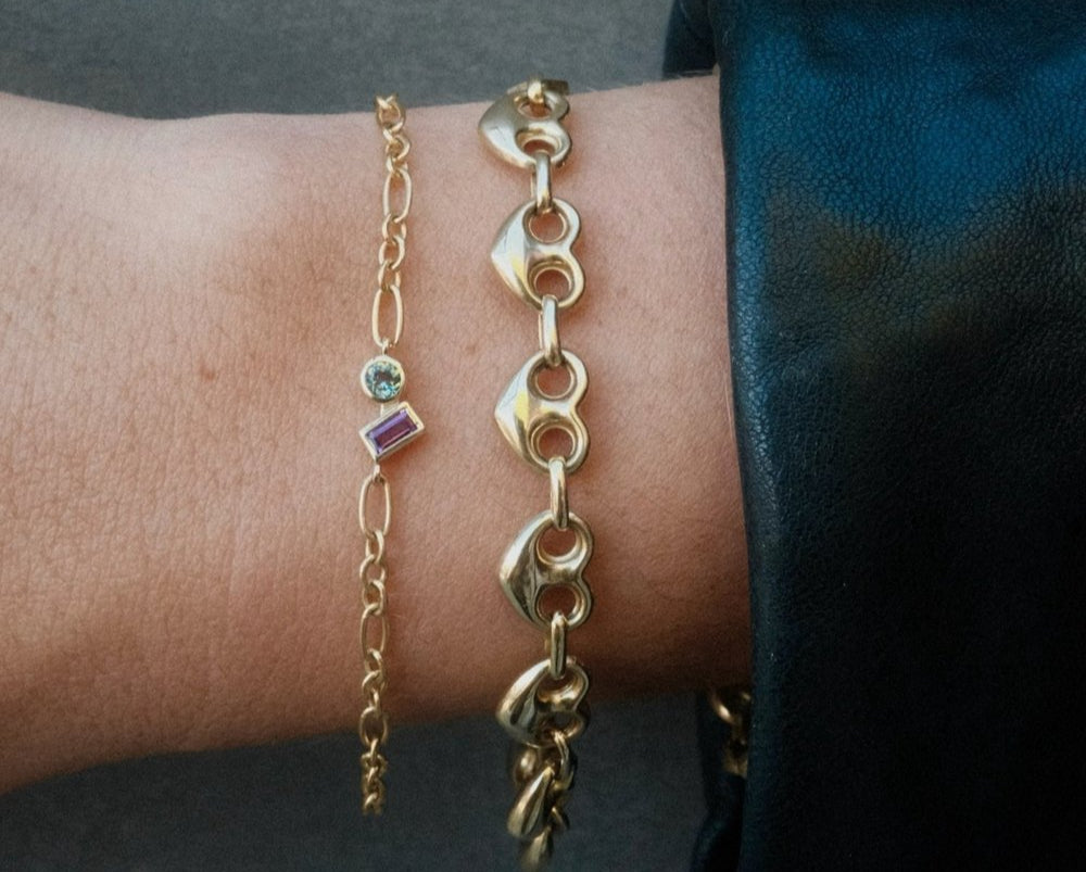 2 14K solid gold bracelets adorned with charms and gemstones, customized.