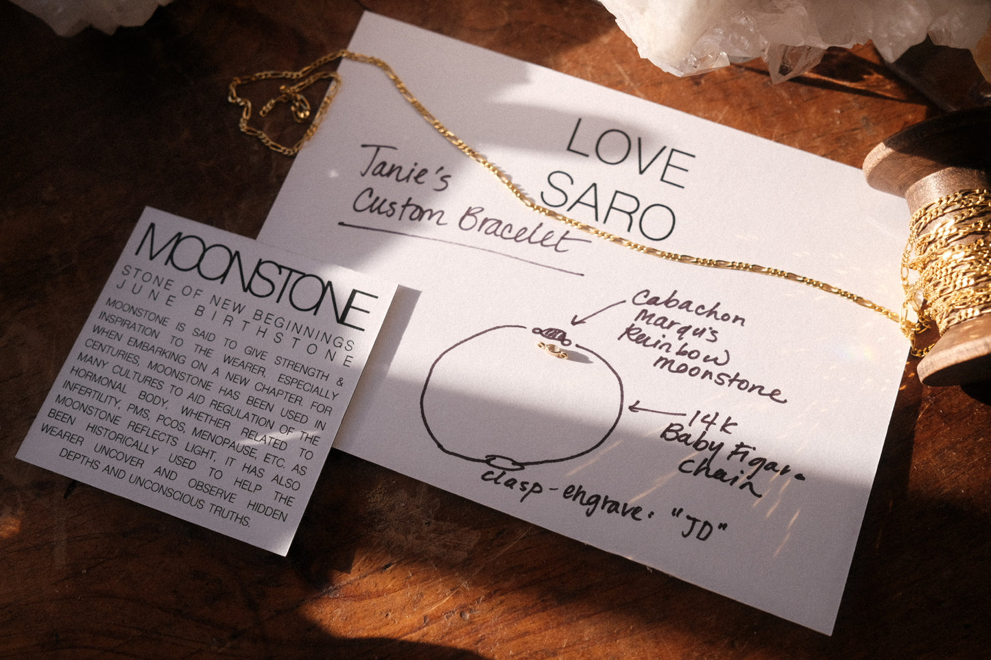 A jewelry designer's sketch before creating a custom 14K solid gold permanent bracelet with moonstone