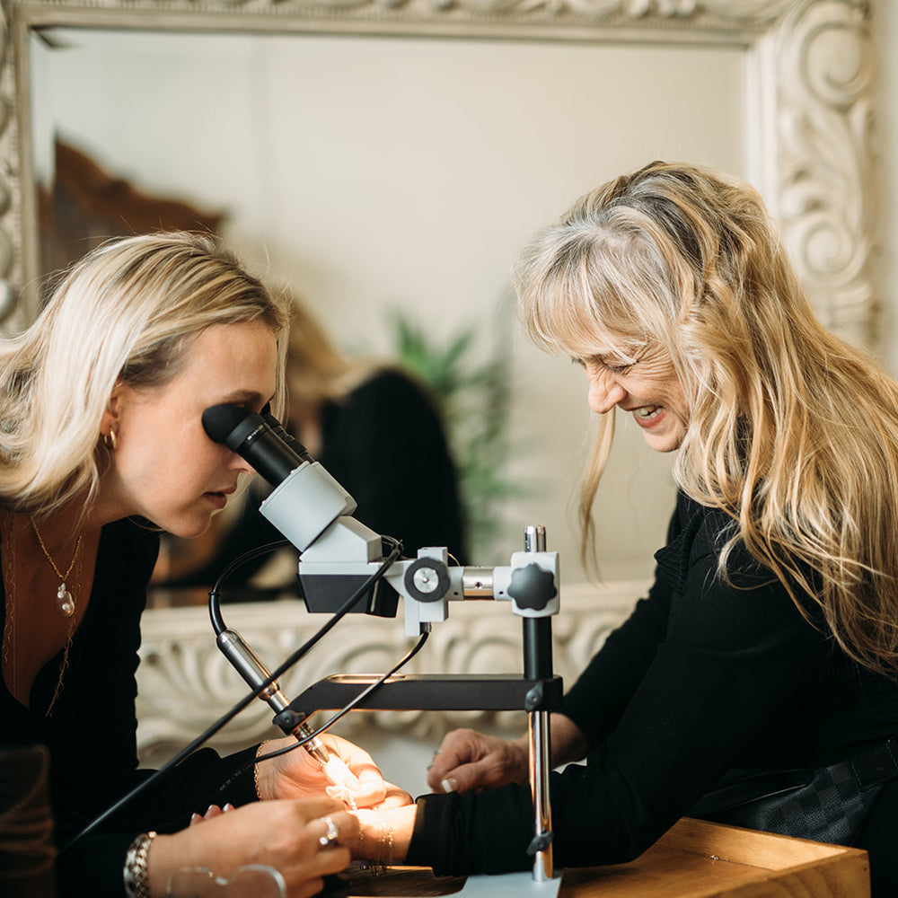 Sacha and Carol in their jewelry studio creating custom permanent jewelry