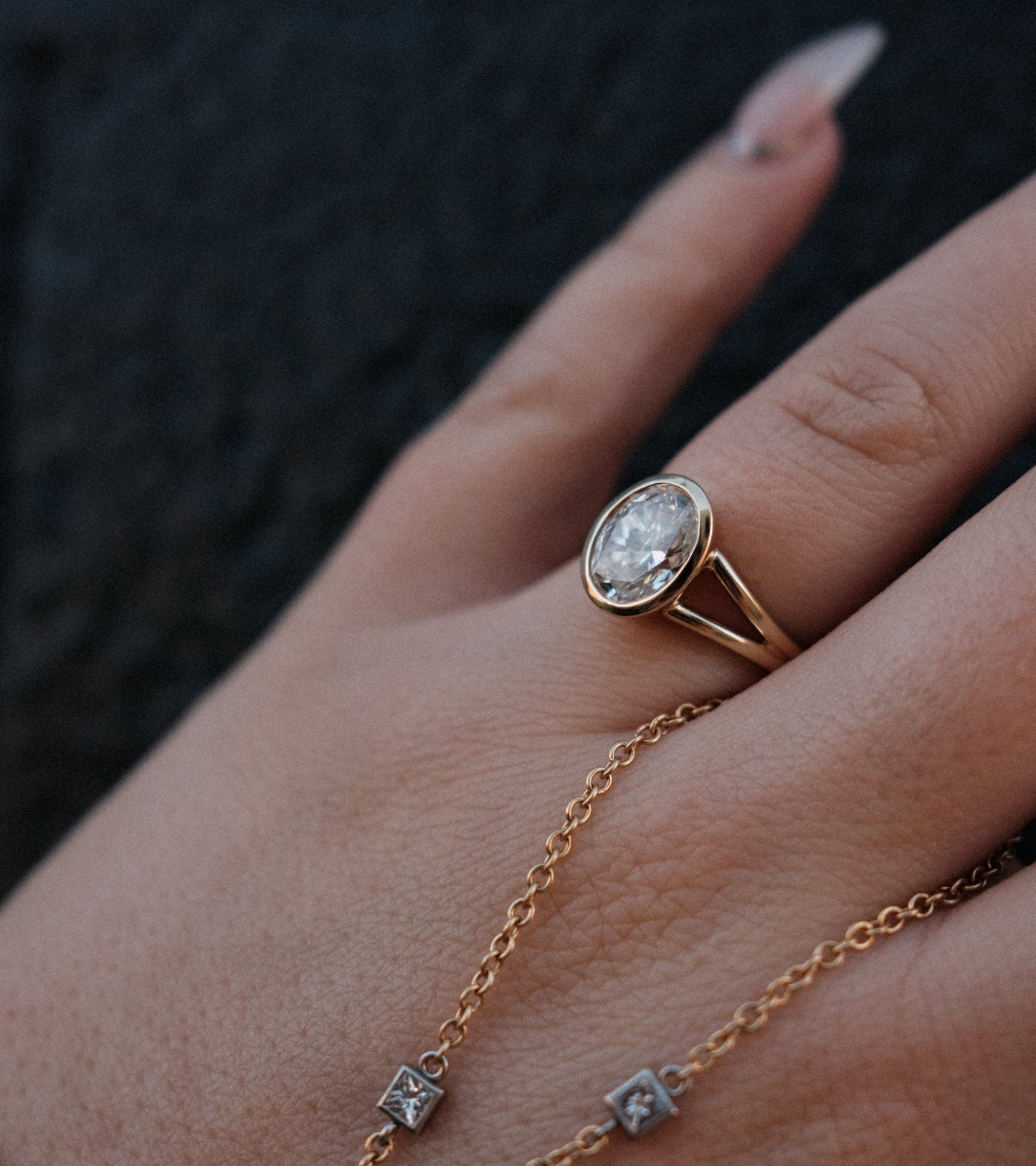 Gold bezel set oval diamond ring 